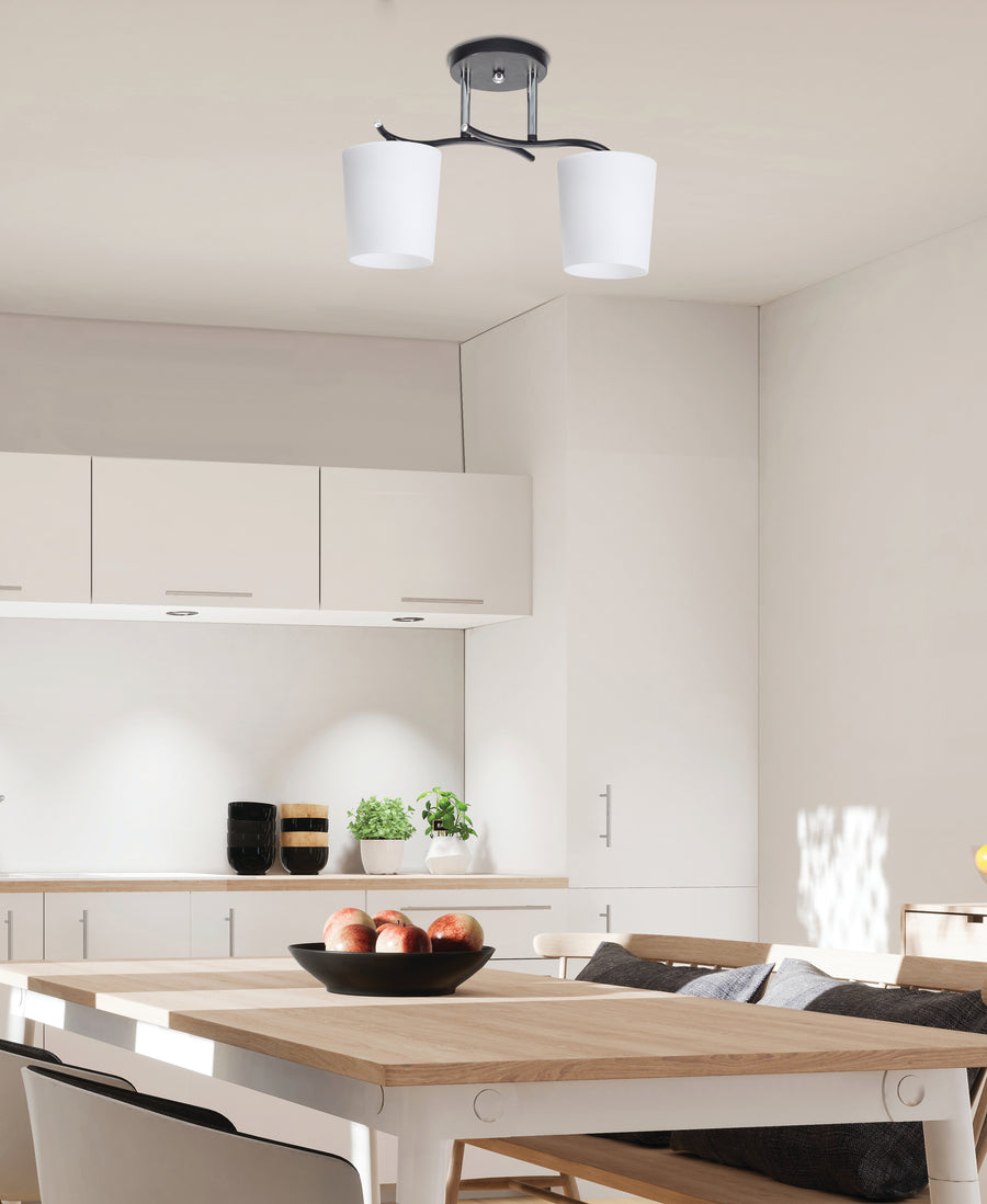 Plafonnier installé au plafond d'une cuisine moderne, au-dessus d'une table en bois clair.