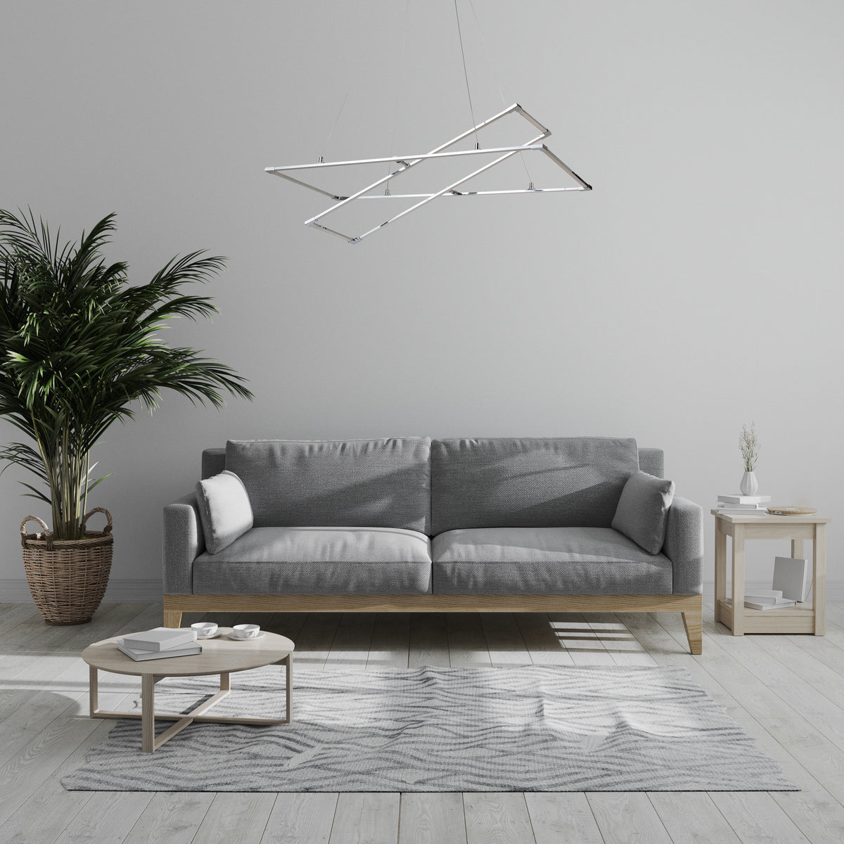 Ambiance salon épuré, luminaire chromé suspendu au-dessus d'un canapé gris