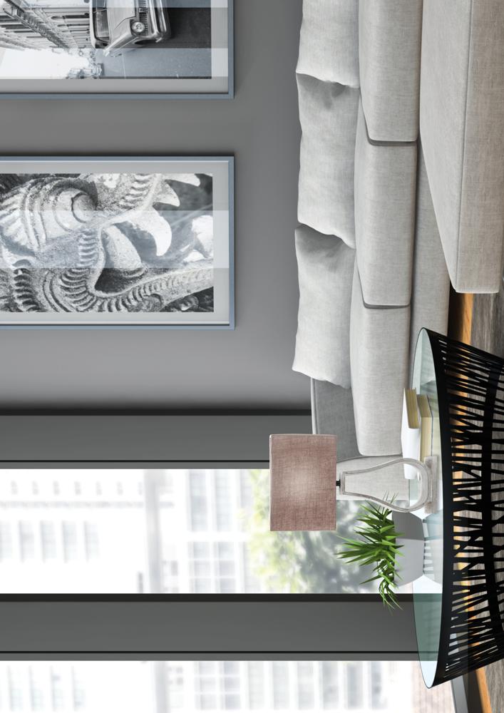 Autre angle de la scène, lampe beige sur la table basse devant le canapé gris