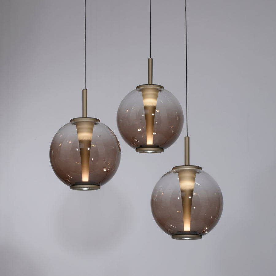 Gros plan sur un globe de verre fumé et sa tige dorée
