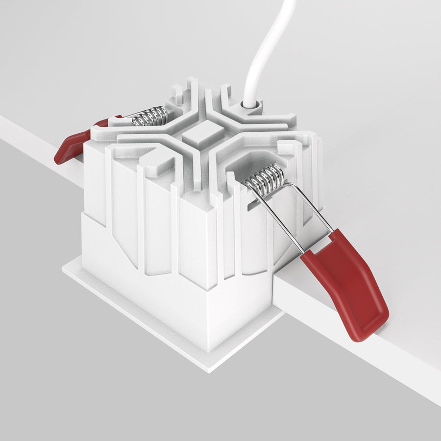 Vue arrière du luminaire montrant les ressorts de fixation et les pinces rouges