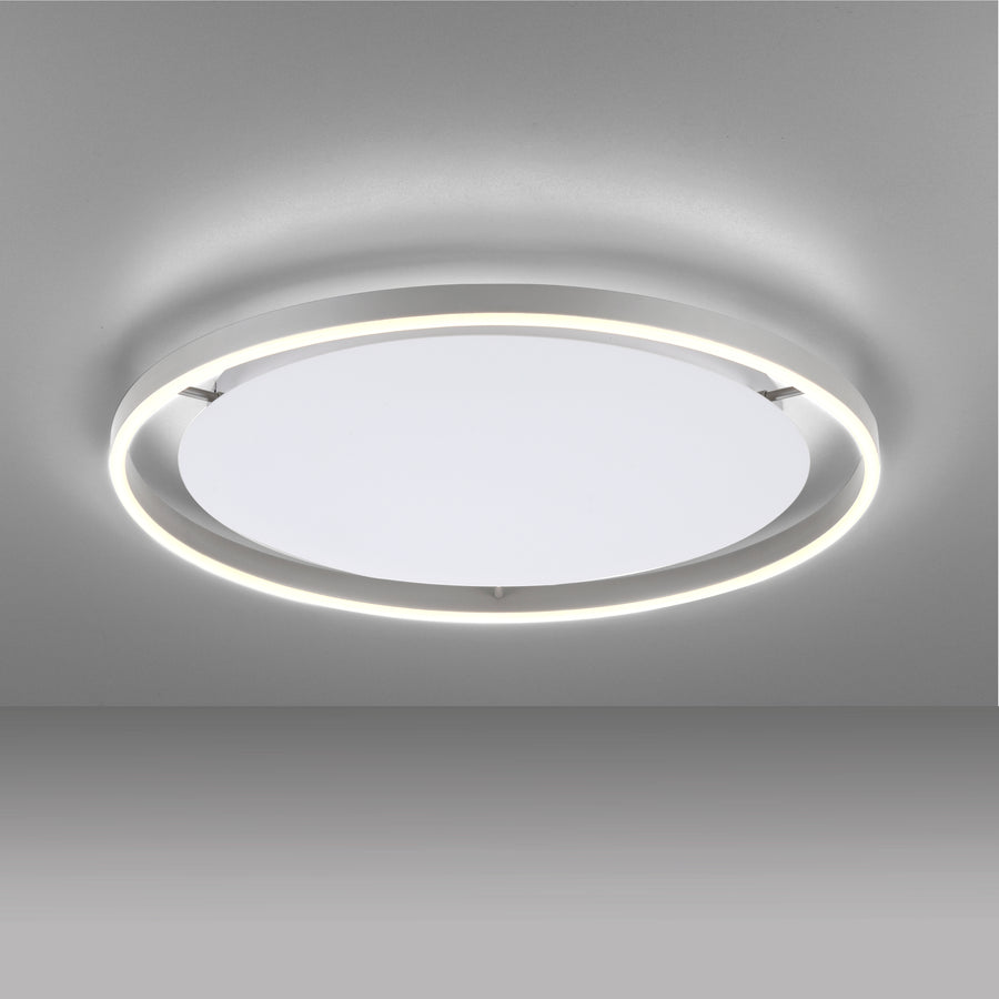 Vue de dessous du plafonnier allumé, montrant l'anneau LED et le diffuseur blanc.