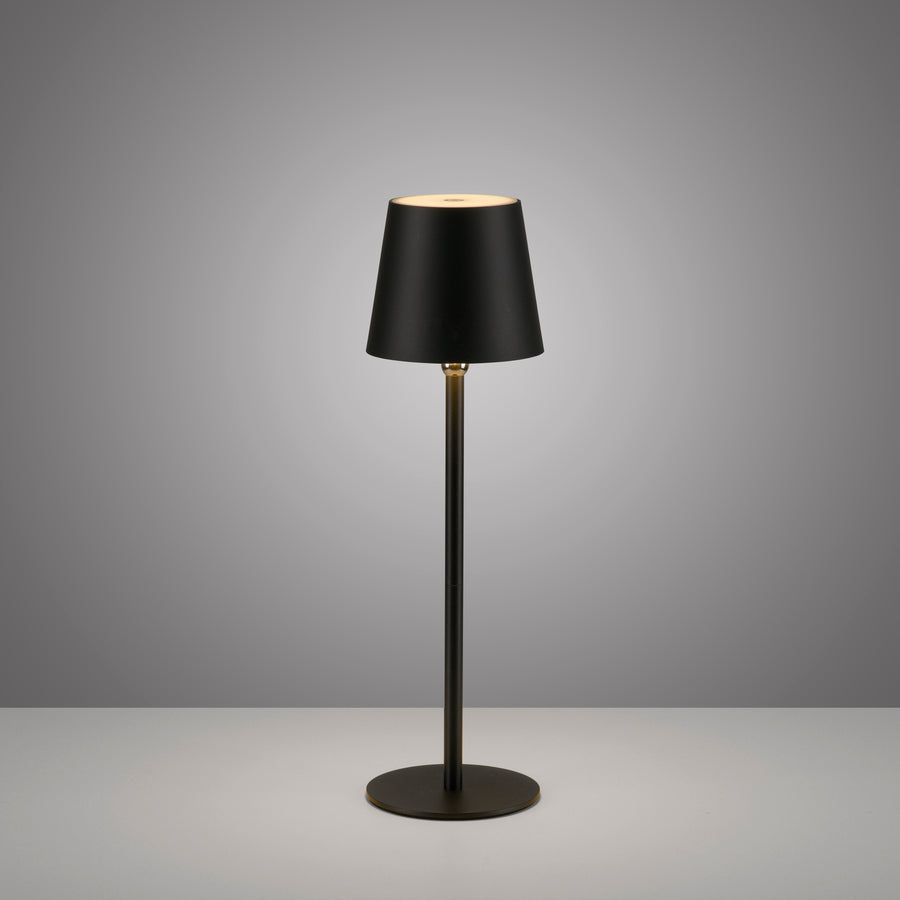 Lampe à poser noire droite sur fond gris, éclairage haut et bas visible.