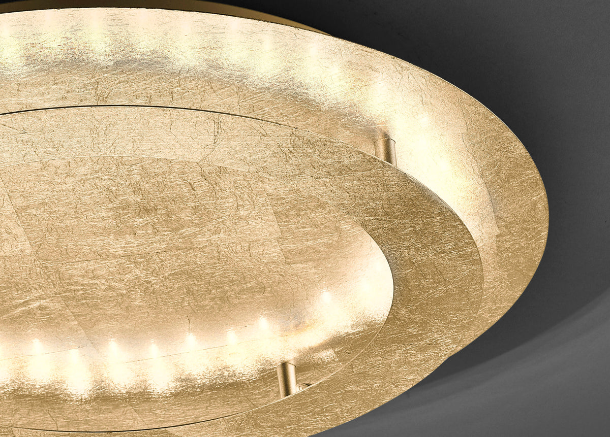 Gros plan sur la texture martelée dorée et les diodes lumineuses du plafonnier