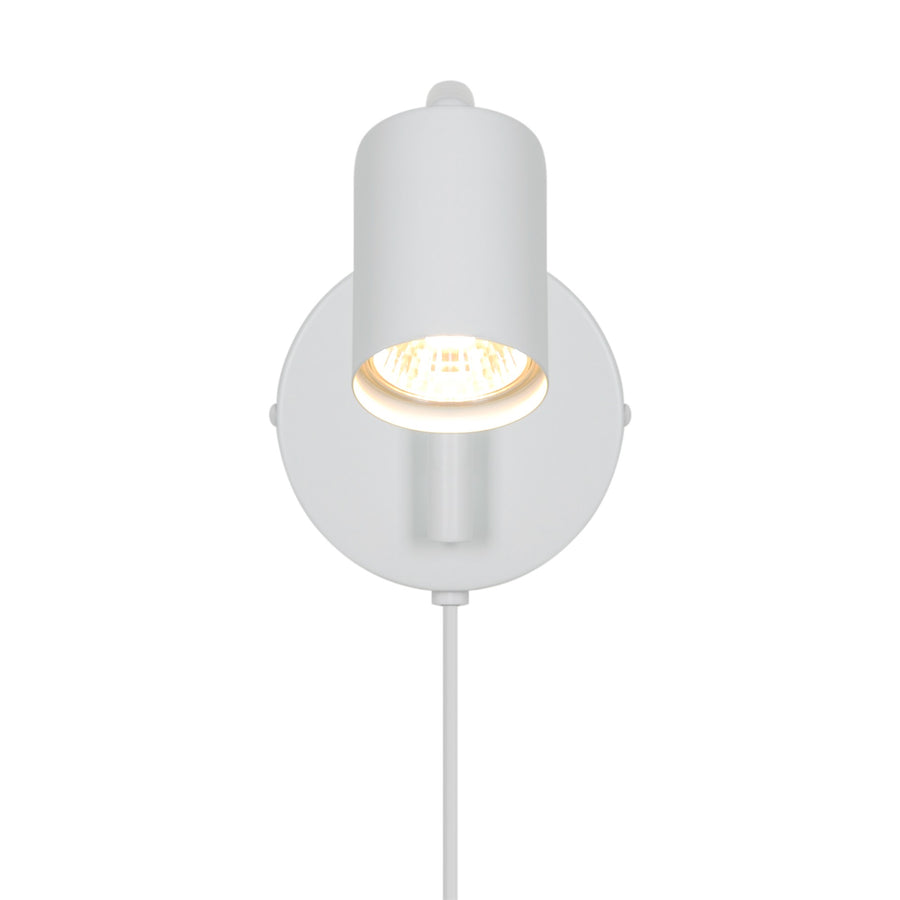 Vue de face du luminaire montrant la tête cylindrique éclairée et sa platine ronde