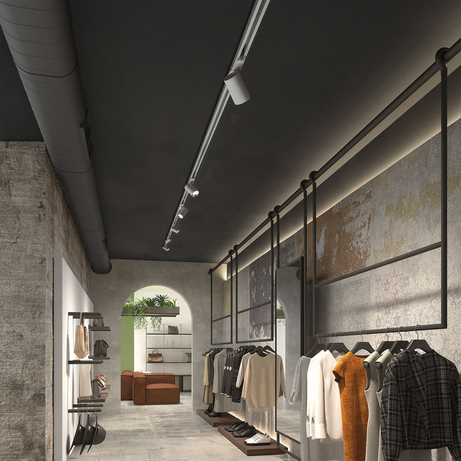 Ambiance de boutique, plusieurs spots orientables sur rail éclairent les portants et allée centrale