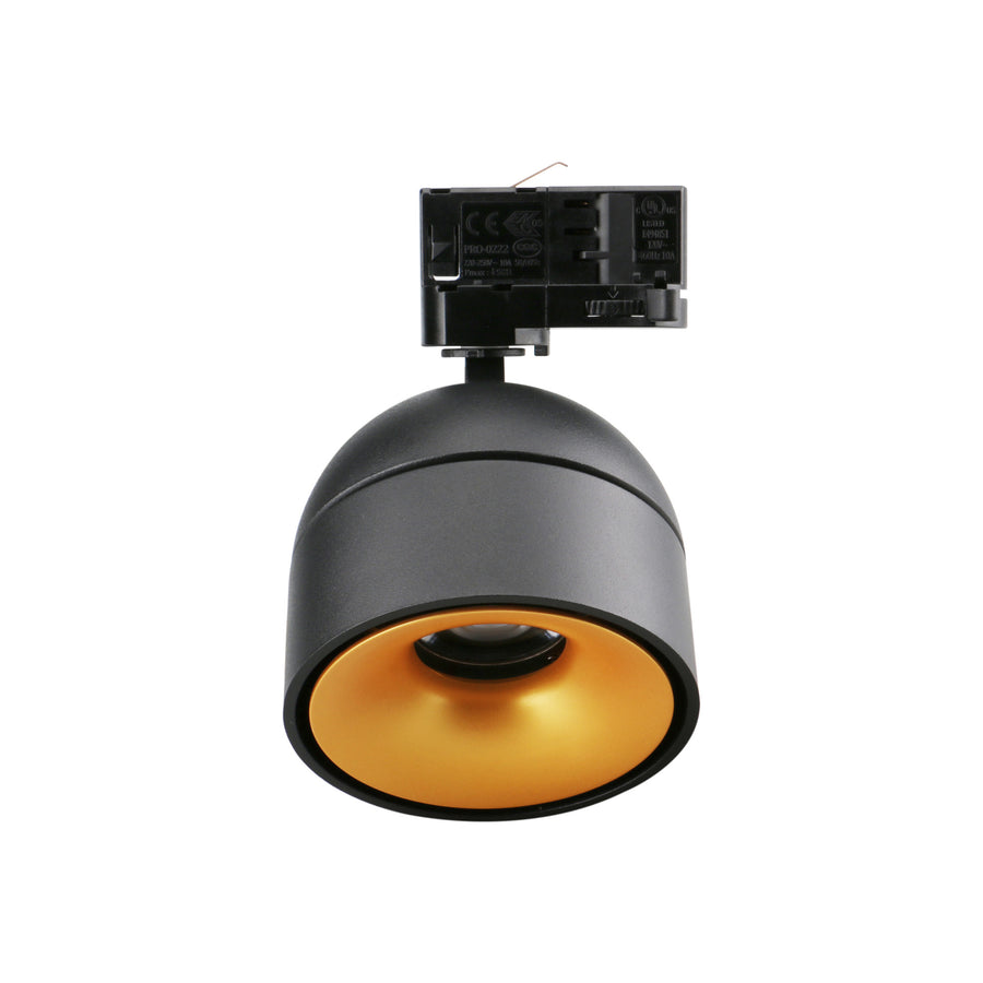 Spot noir vu de dessous, réflecteur doré et module LED au centre.