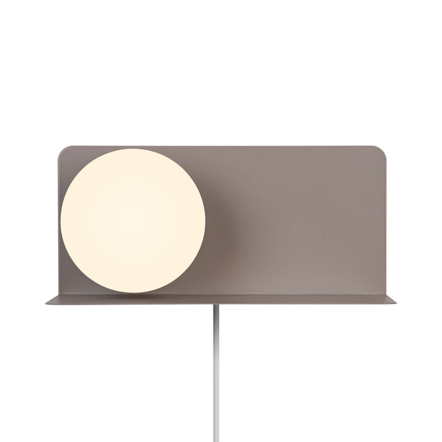 Face avant sur fond blanc, diffuseur rond éteint et plateau en métal beige.