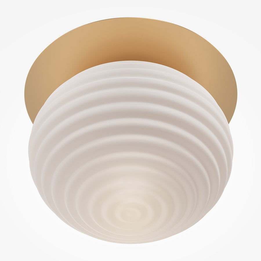 Vue rapprochée du bas de la sphère striée, verre opalin diffusant une lumière chaude