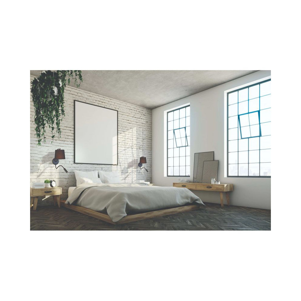 Mise en ambiance d'une chambre avec applique murale noire fixée sur un mur de briques.