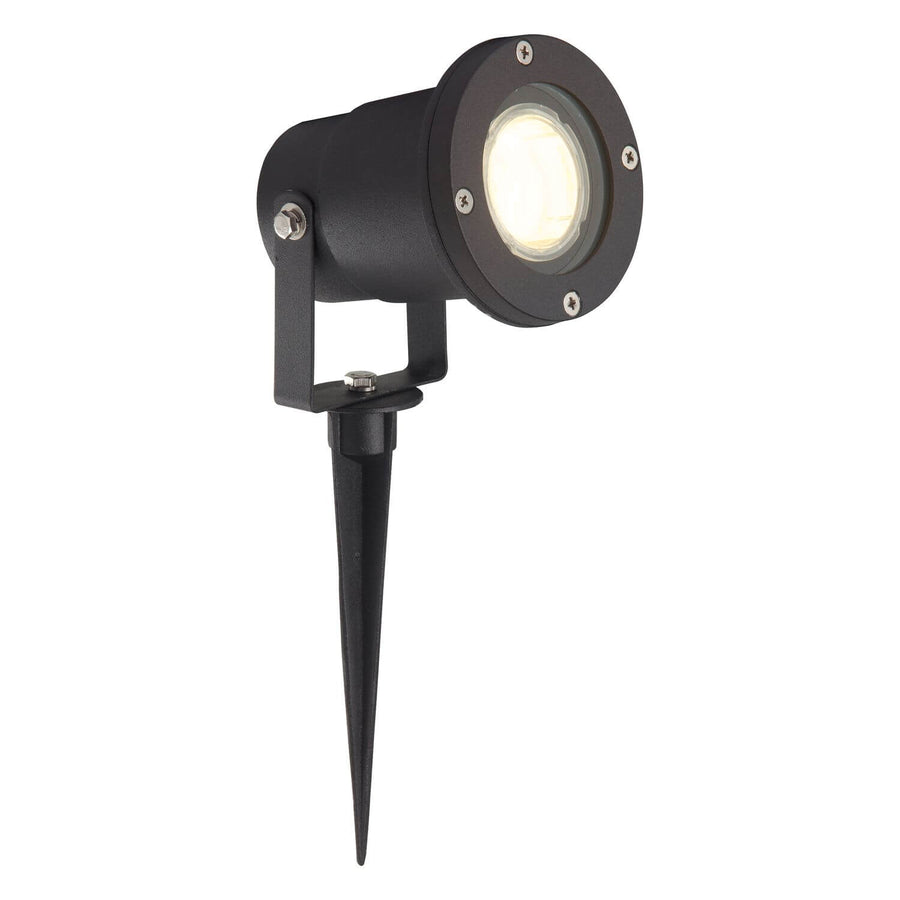 Projecteur extérieur noir à piquer, tête cylindrique orientable, vue de trois quarts sur fond blanc.