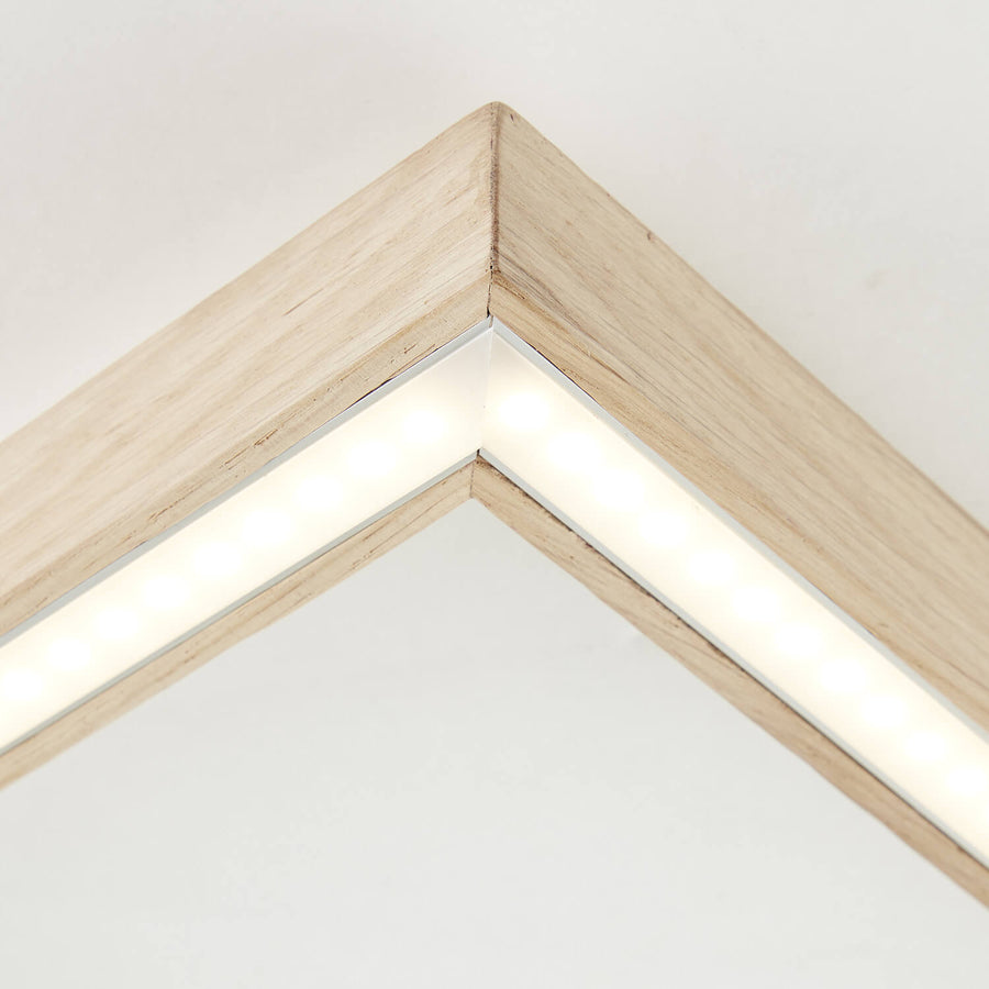 Détail rapproché d'un angle du cadre avec bandeau LED allumé