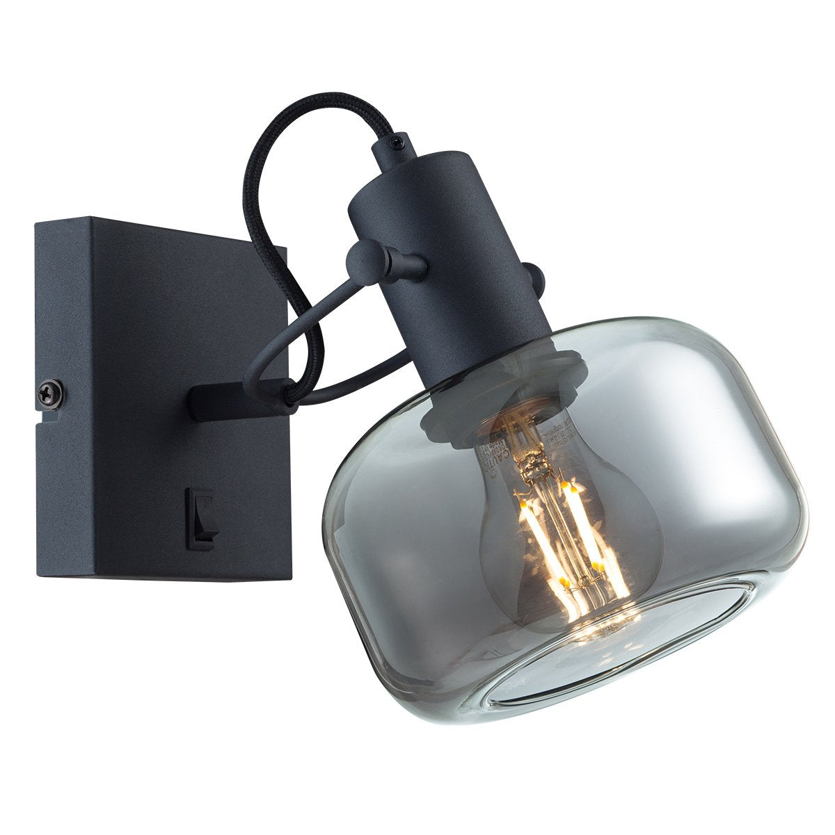Gros plan sur l'abat-jour en verre transparent et l'ampoule à filament du luminaire mural noir.