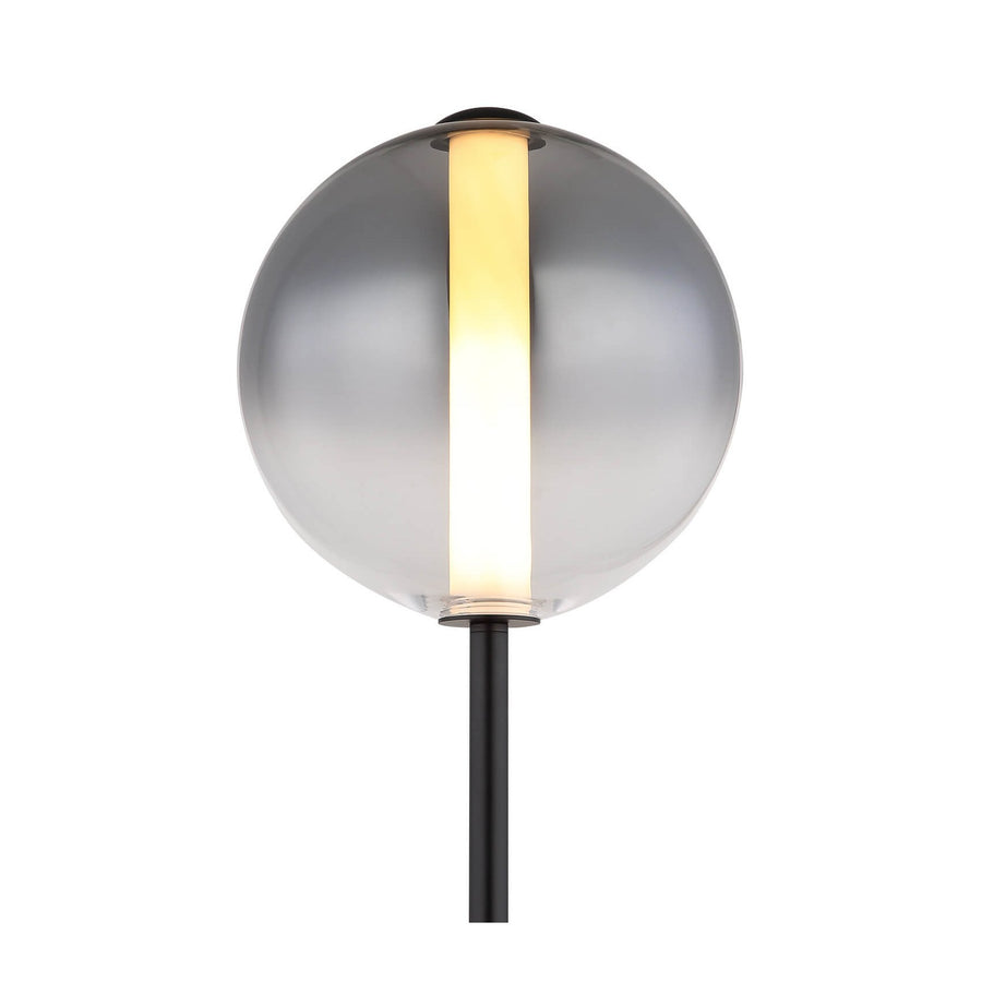 Gros plan du globe en verre dépoli avec tige lumineuse verticale et pied noir.