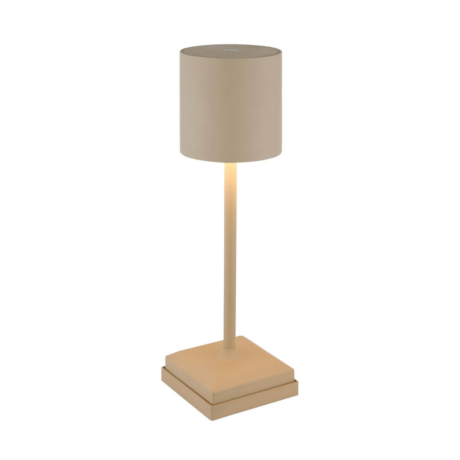 Lampe à poser beige allumée, vue de face sur fond blanc