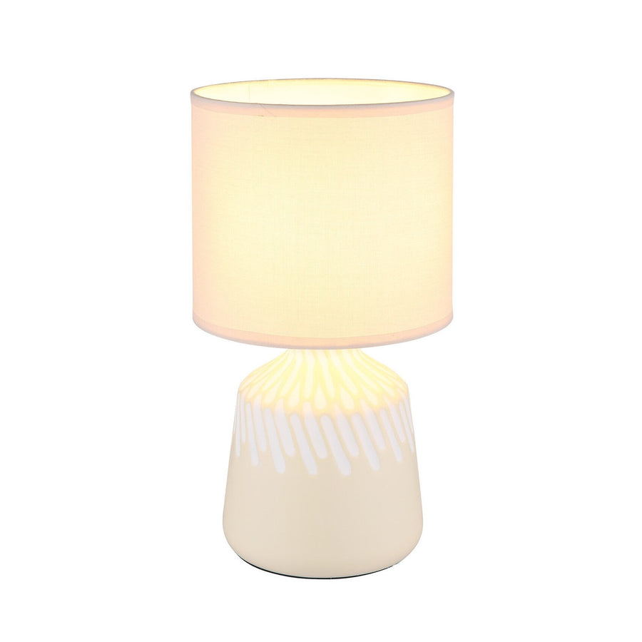 Lampe de face, abat-jour cylindrique allumé sur fond blanc neutre