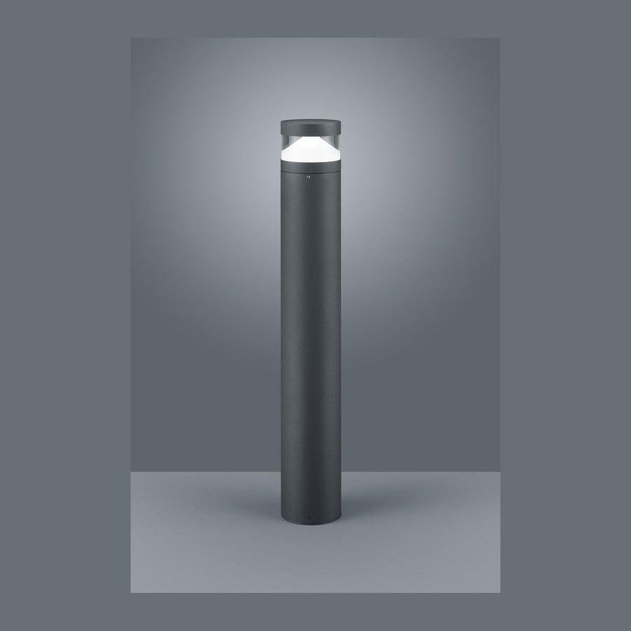 Borne lumineuse cylindrique anthracite présentée de face sur fond gris studio.