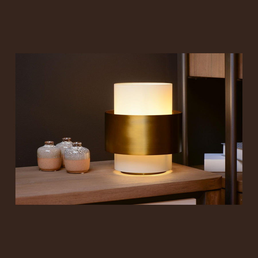 Lampe allumée posée sur une étagère en bois avec trois petits vases