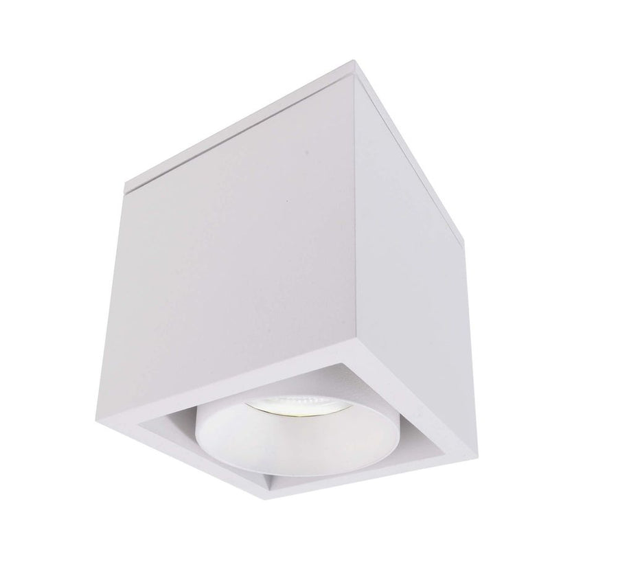 Autre angle du boîtier carré blanc, diffuseur circulaire éteint sous la base.