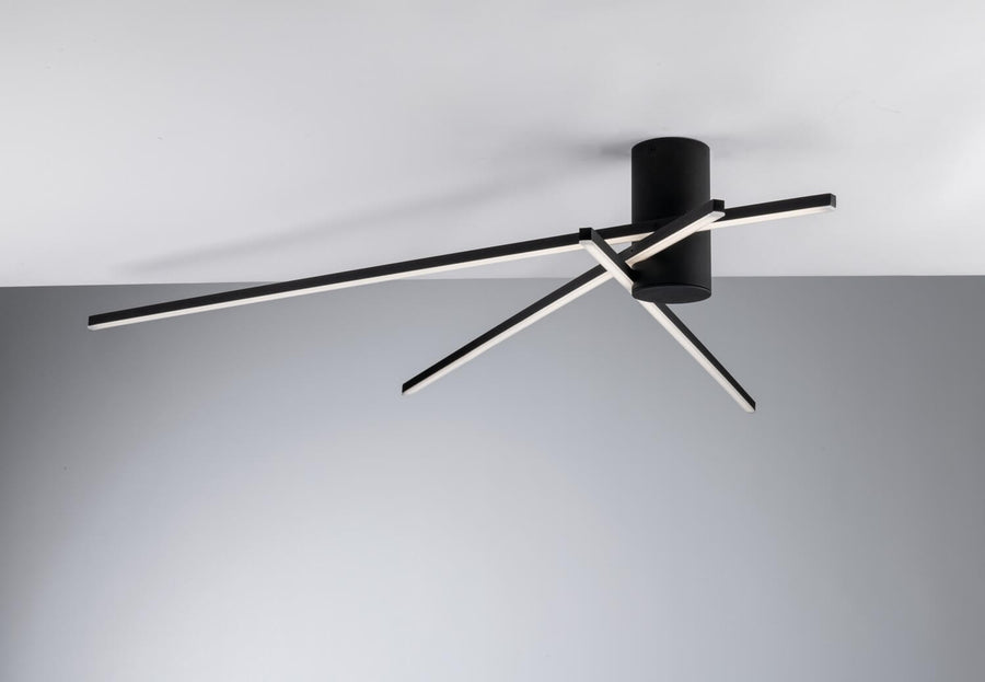 Détail du socle cylindrique noir et des bras LED croisés éclairés