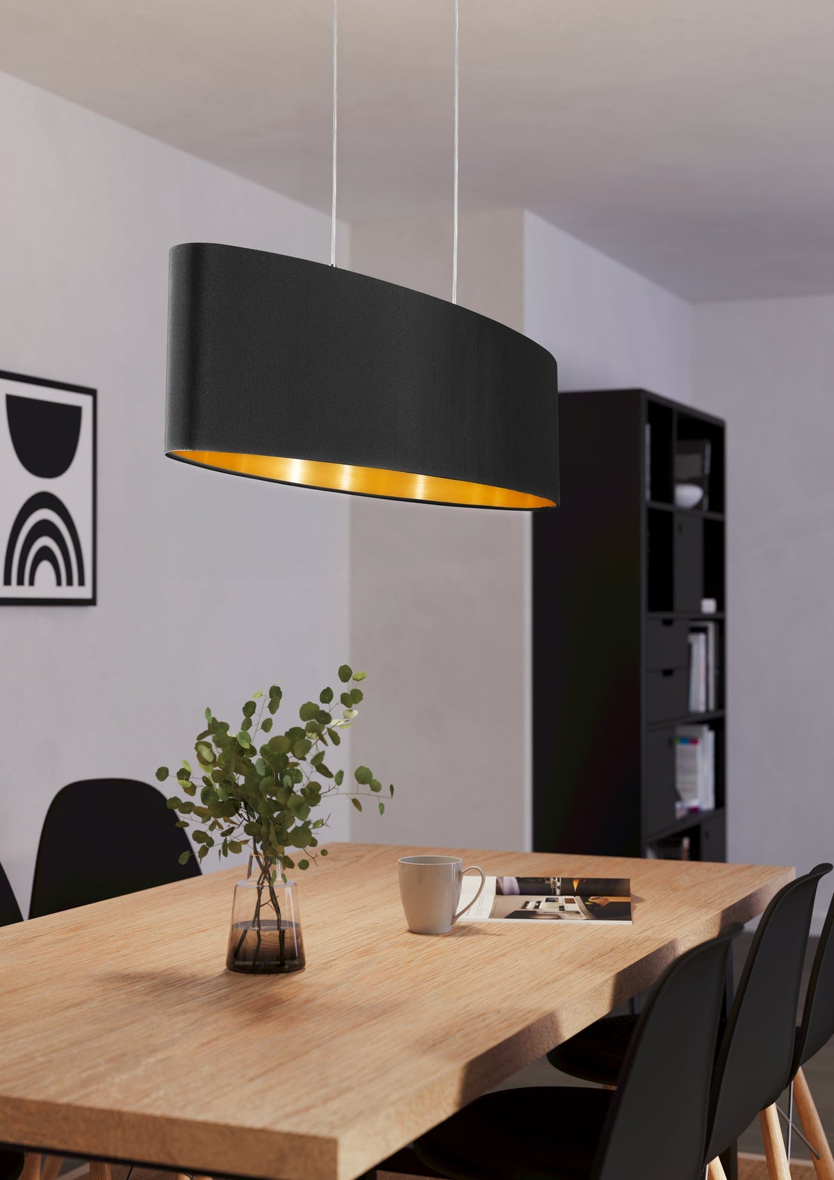 Mise en ambiance au-dessus d'une table à manger en bois clair dans un intérieur moderne