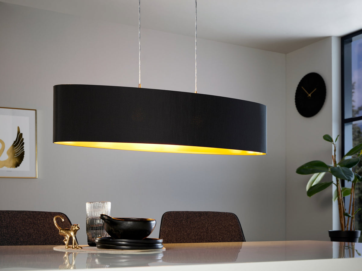 Mise en ambiance au-dessus d'une table à manger, abat-jour noir éclairé intérieur or