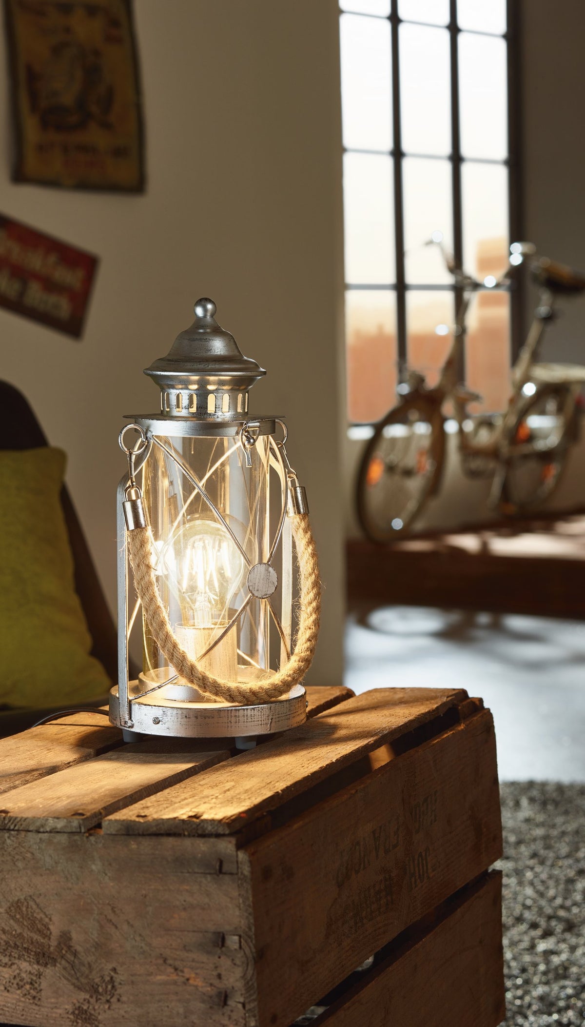 Mise en ambiance de la lampe allumée sur caisse avec vélo et fenêtre en arrière-plan