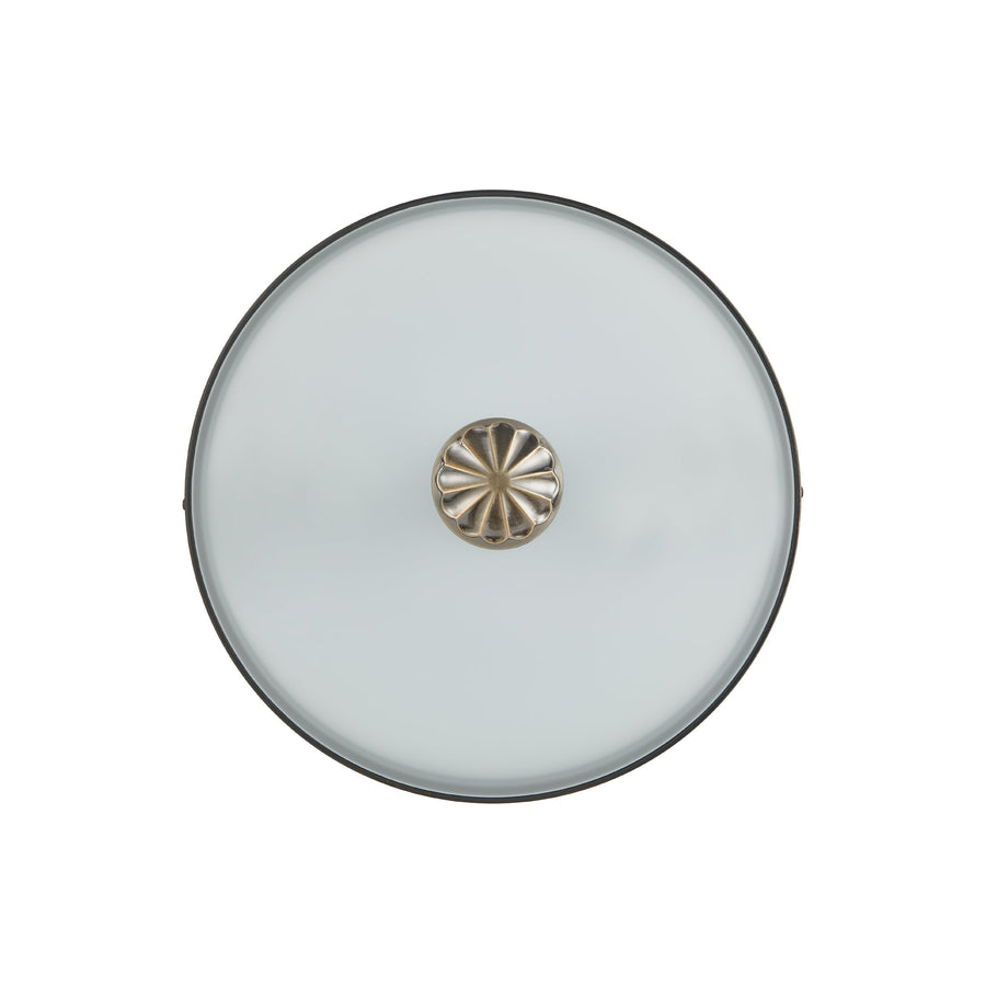 Vue par dessous montrant le verre circulaire et la finition centrale décorative.
