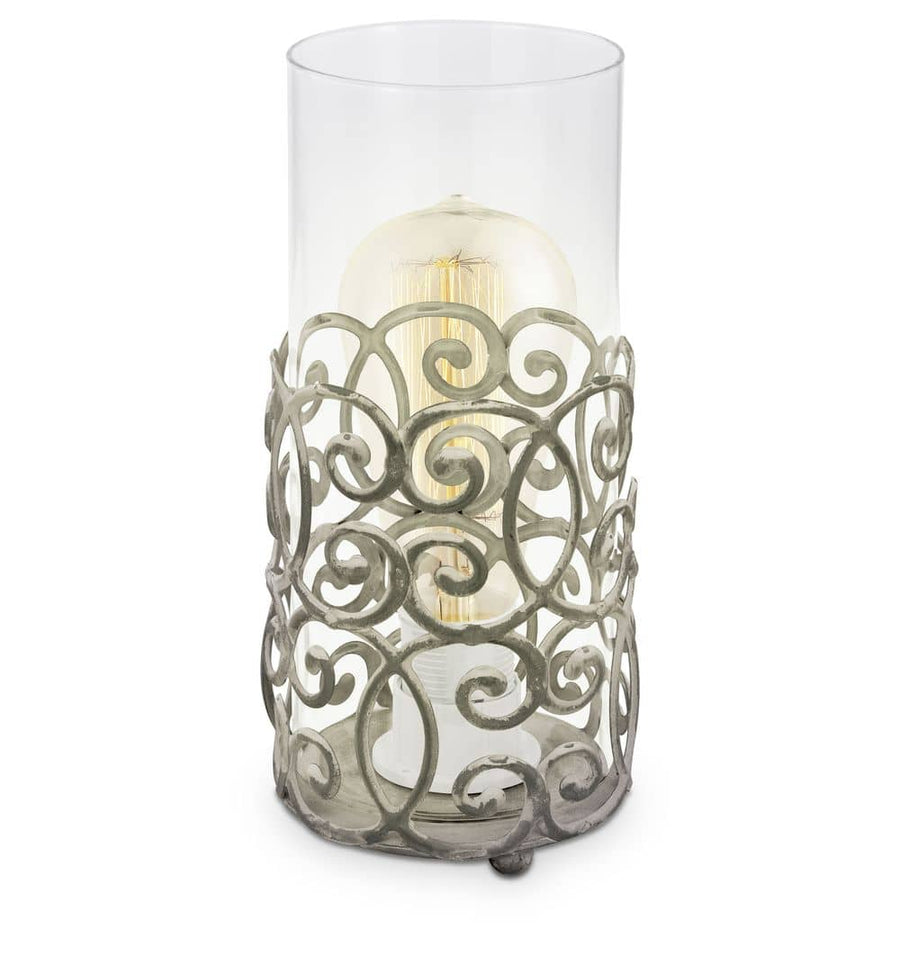 Lampe à poser de face, verre cylindrique transparent et socle métallique ajouré marron