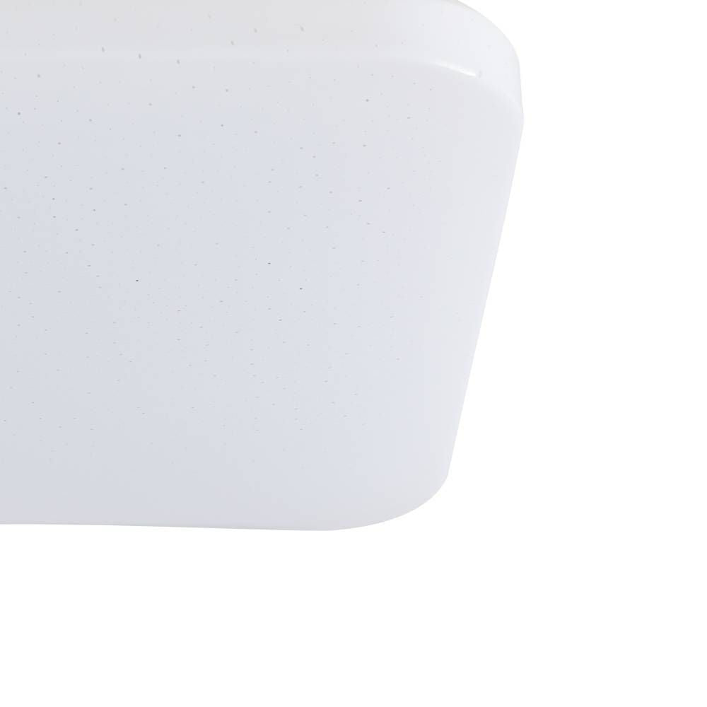 Gros plan sur l'angle arrondi et la surface pailletée du diffuseur blanc