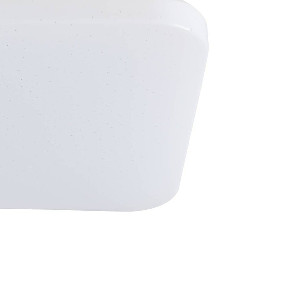 Gros plan sur l'angle arrondi et la surface pailletée du diffuseur blanc