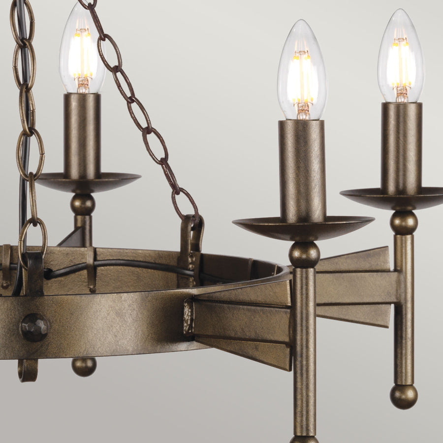 Détail des bras métalliques, coupelles et douilles en bronze avec ampoules bougies allumées.