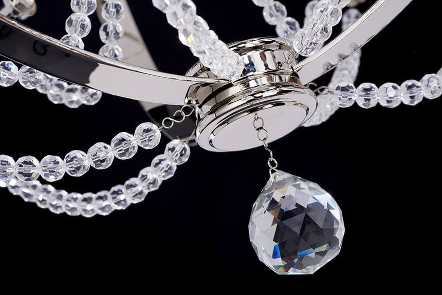 Gros plan sur la goutte de cristal taillé et les rangées de perles