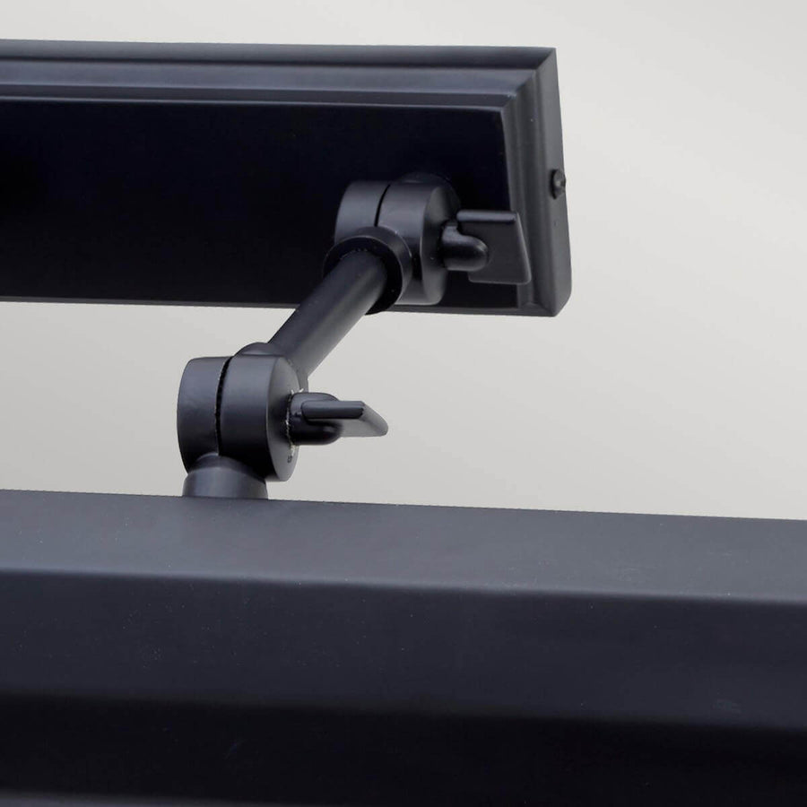 Détail du mécanisme d'articulation avec vis de verrouillage et rotule orientable.