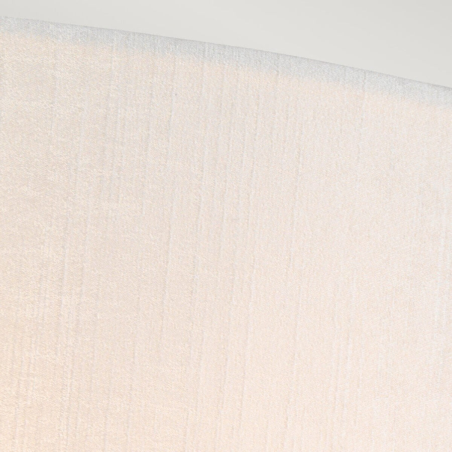 Gros plan sur la texture tissée et le grain de l'abat-jour crème