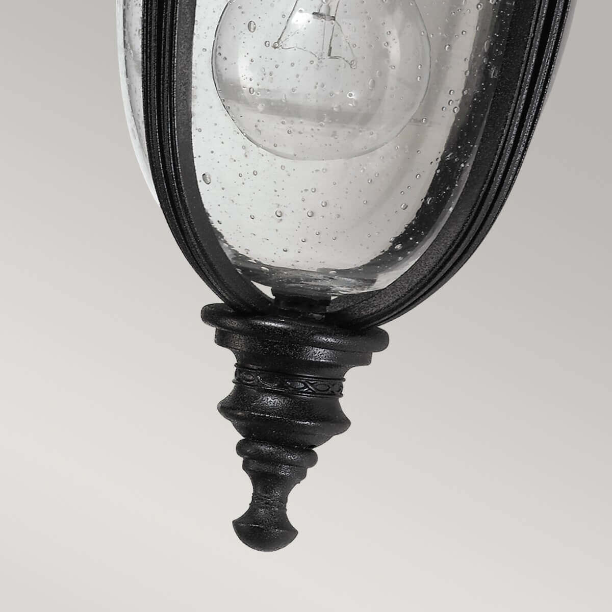 Détail de la pointe inférieure ouvragée en métal noir sous le verre.
