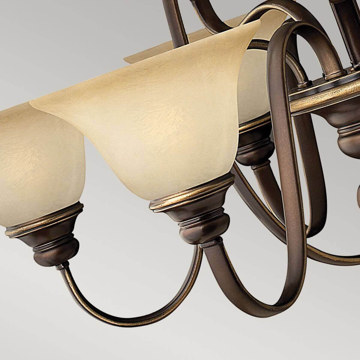 Détail des abat-jours en albâtre et des bras recourbés en bronze