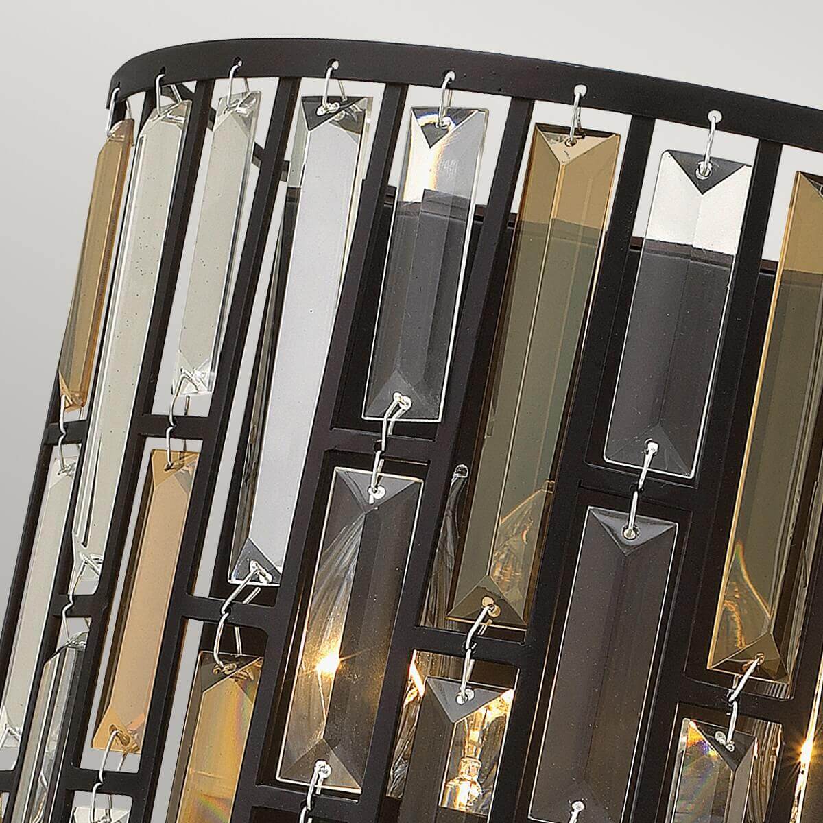Détail rapproché des prismes de cristal transparents et fumés accrochés au cadre noir