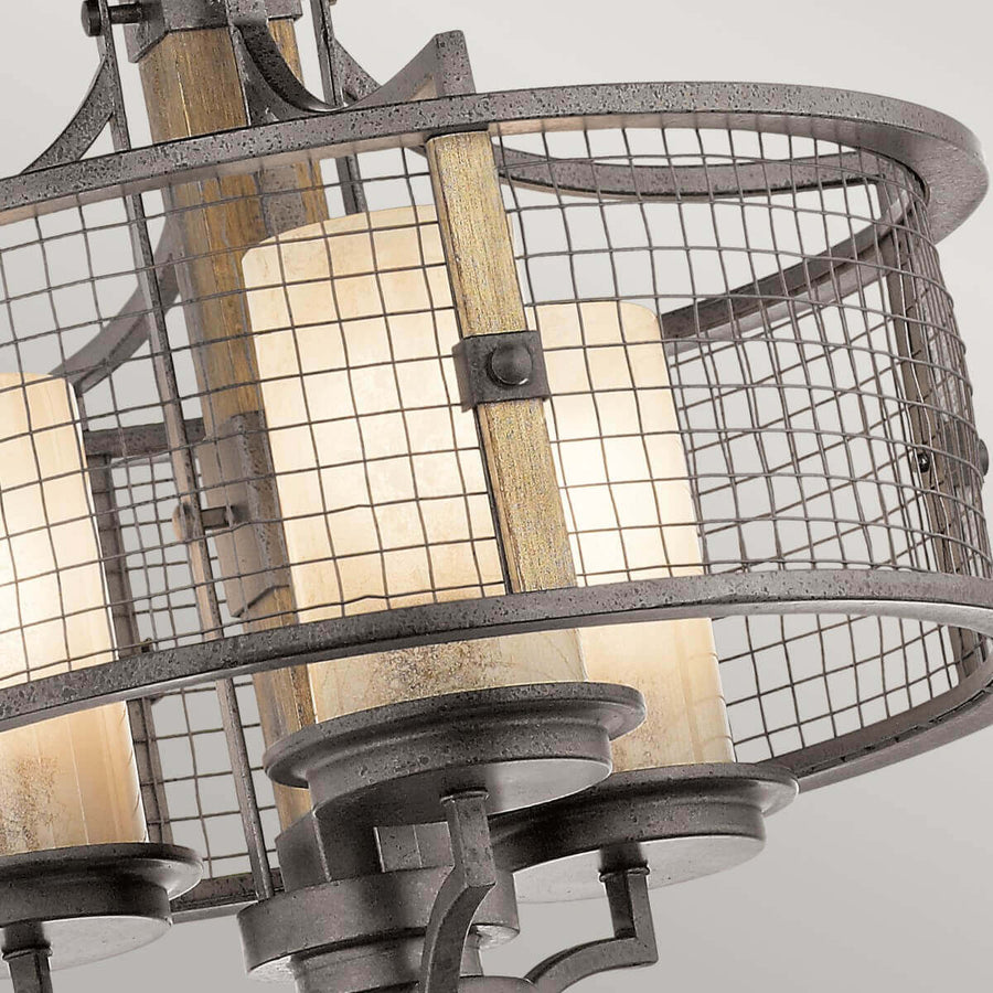 Vue rapprochée des abat-jours cylindriques en verre derrière la grille métallique festonnée
