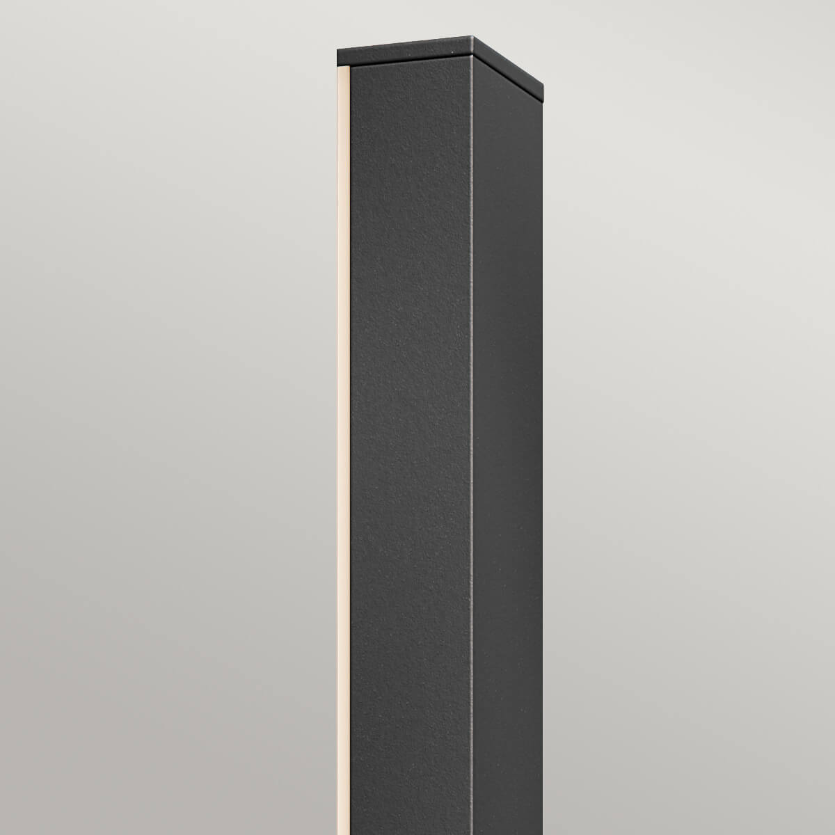Gros plan sur le haut de l'applique noire, finition texturée et bord lumineux sur fond gris.