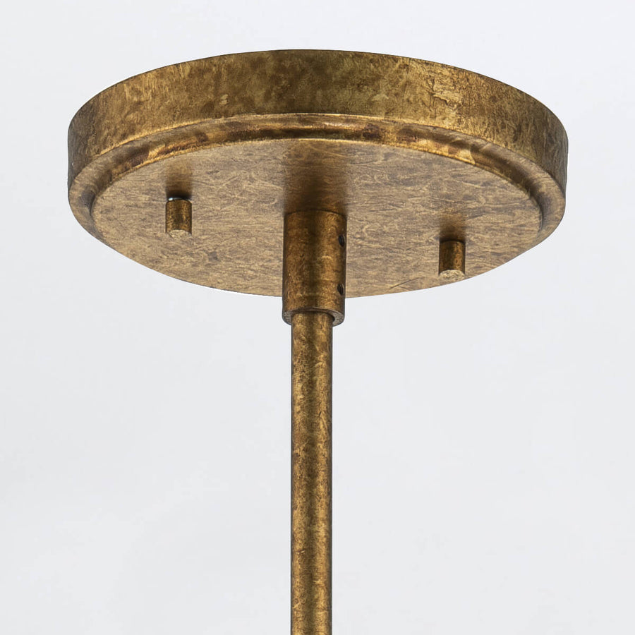 Détail de la platine ronde dorée fixée au plafond avec sa tige