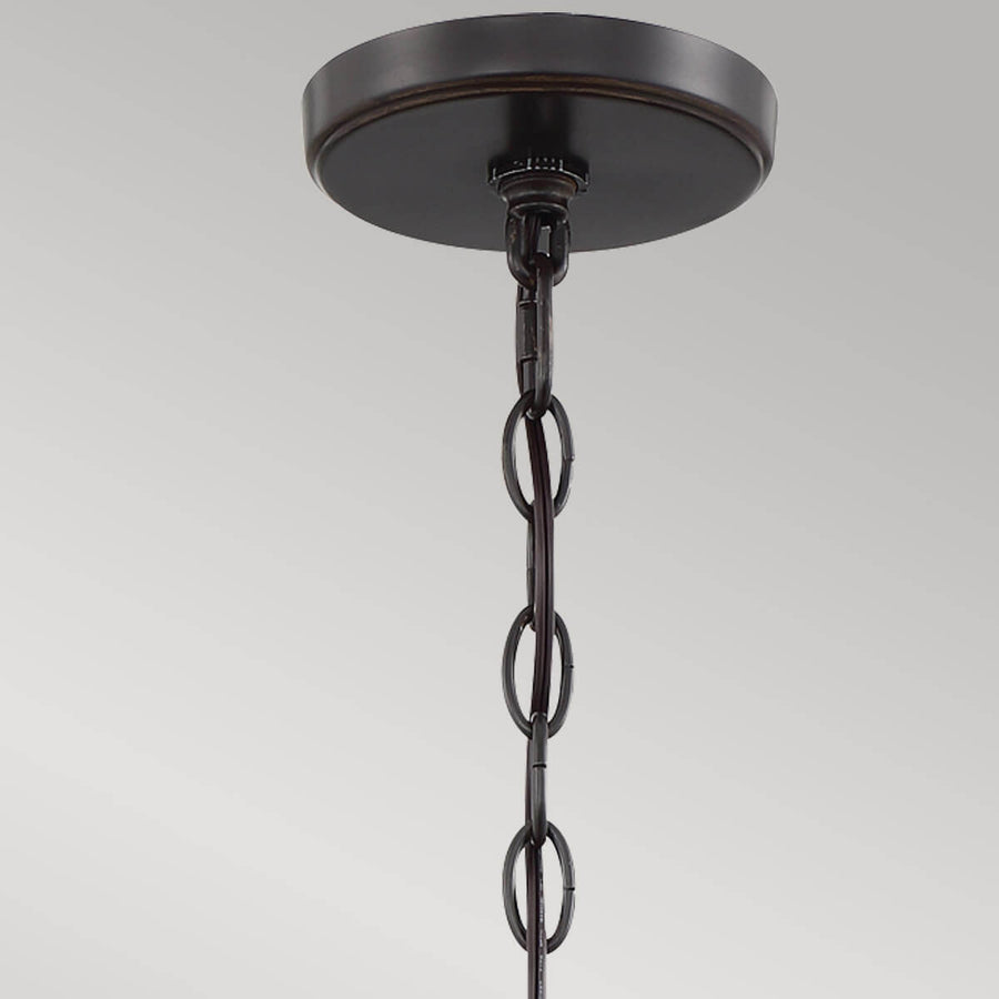 Gros plan sur la platine de fixation au plafond et la chaîne métallique de suspension.