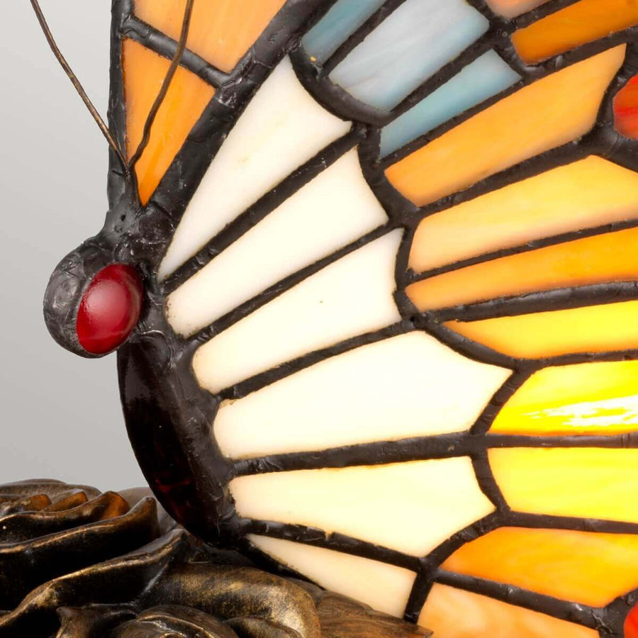 Gros plan sur la tête du papillon, œil rouge et ailes crème