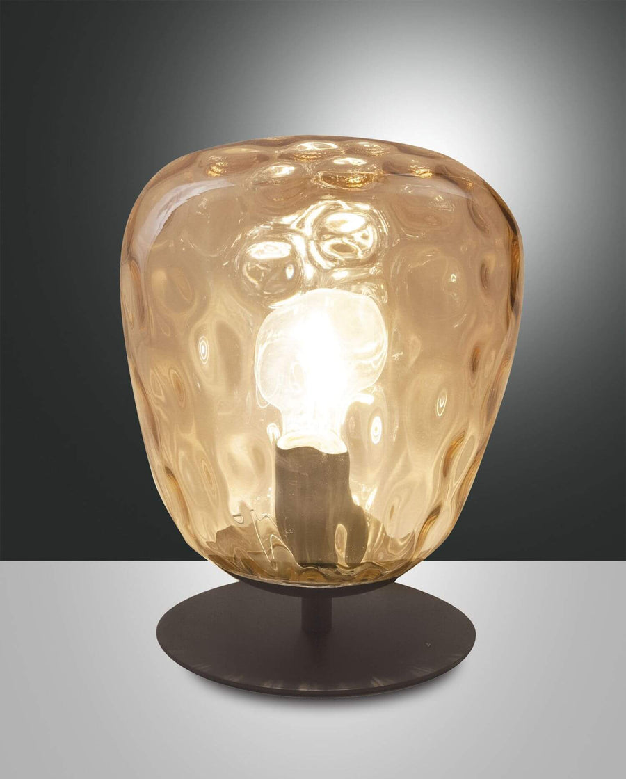 Lampe à poser ambrée, verre martelé en forme de boule sur socle noir