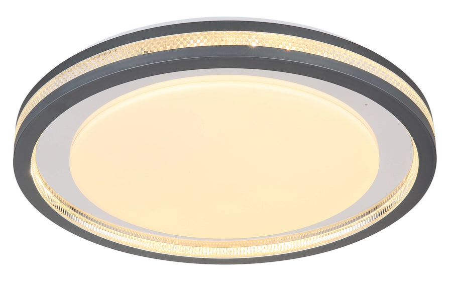 Plafonnier allumé en lumière chaude, halo périphérique sous le cadre gris