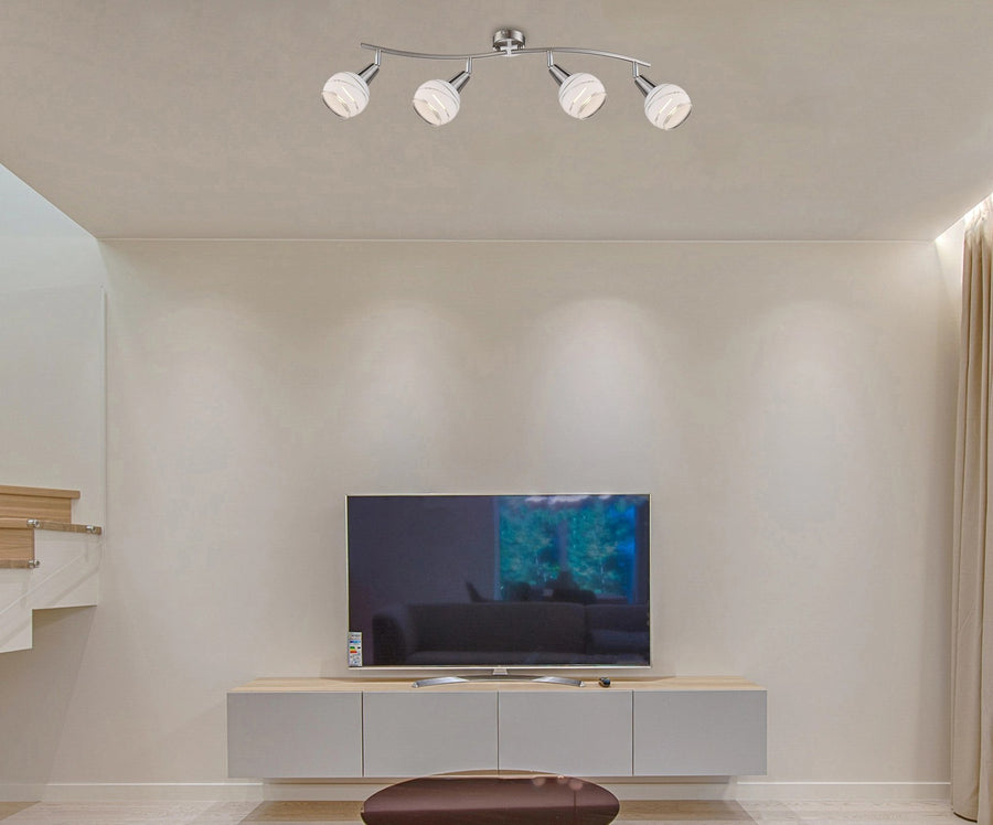Plafonnier installé au plafond d'un salon, au-dessus d'un meuble TV, éclairage allumé.