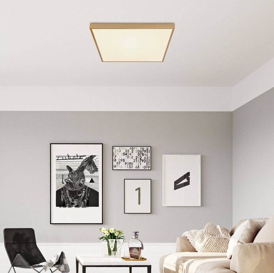 Plafonnier carré en laiton installé au plafond d'un salon moderne.