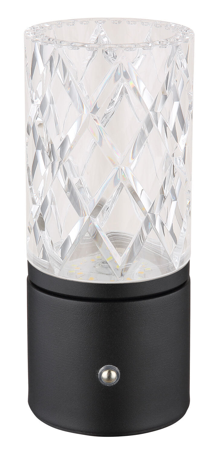 Lampe éteinte de face, abat-jour cylindrique transparent à motifs losangés, base noire mat et interrupteur.