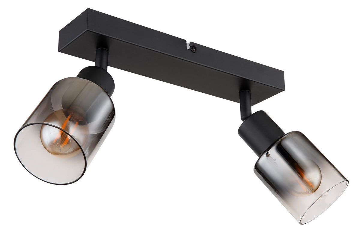 Détail des douilles orientables et des verres fumés sur la platine noire, fond blanc.