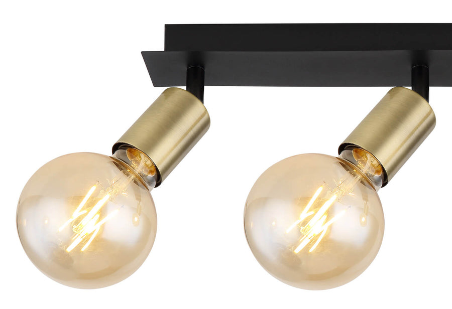 Zoom sur deux ampoules ambrées allumées et leurs douilles dorées inclinées